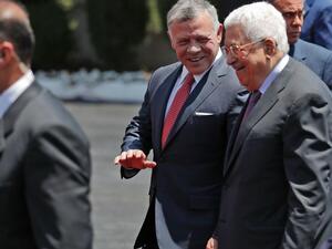 Jordan's King Abdullah II, center, walks Monday with Palestinian leader Mahmoud Abbas. (AHMAD GHARABLI/Getty-AFP )