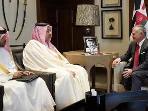 King Abdullah II, right, receiving Qatar's Deputy Prime Minister Khalid bin Mohammed Al-Attiyah, centre, in Amman on 17 April (AFP)