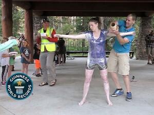 Idaho man covers wife in plastic wrap for Guinness World Record. (Video Screenshot)