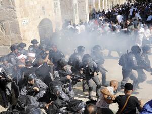 Israeli security forces fire sound grenades inside the Al-Aqsa Mosque compound in the Old City of Jerusalem on August 11, 2019, as clashes broke out during the overlapping Jewish and Muslim holidays of Eid al-Adha and the Tisha B'av holdiay. (AFP)