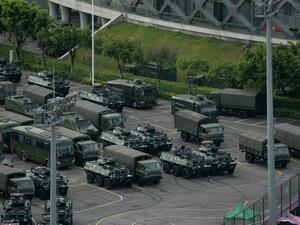Trucks and armoured personnel carriers are seen parked at the Shenzhen Bay stadium in Shenzhen, bordering Hong Kong in China's southern Guangdong province, on August 16, 2019. (AFP)