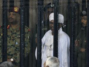 Sudan's deposed military ruler Omar al-Bashir stands in a defendant's cage during the opening of his corruption trial in Khartoum on August 19, 2019. (AFP/ File Photo)