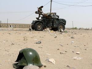 A Fighter stands atop a military vehicle in Yemen (AFP)