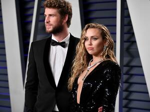 Liam Hemsworth (L) and Miley Cyrus attend the 2019 Vanity Fair Oscar Party hosted by Radhika Jones at Wallis Annenberg Center for the Performing Arts in Beverly Hills, California. (AFP)