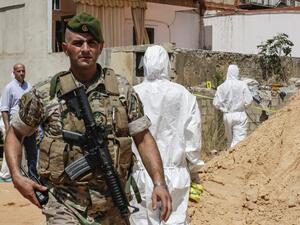 A Lebanese army soldier walks past military intelligence forensic investigators inspecting the scene where two drones came down in the vicinity of a media centre of the Shiite Hezbollah movement earlier in the day, in the south of the capital Beirut on August 25, 2019. (AFP/ File Photo)