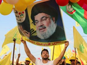 Supporters of the Lebanese Shiite Hezbollah movement carry ballons, party flags and a photograph of the movement's leader Hasan Nasrallah, in the town of Al-Ain in Lebanon's Bekaa valley on August 25, 2019. (AFP/ File Photo)