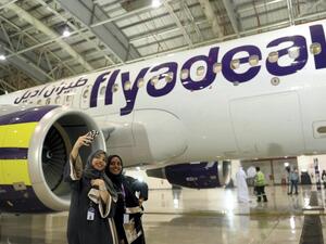 Female cabin crew pose in front of a flyadeal aircraft. (AFP)