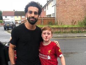 Ouch! Mohamed Salah with Louis - and his cut nose - after the 11-year-old crashed into a lamppost chasing him. (Liverpool Echo)