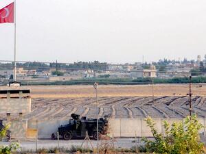 A Turkish military truck patrols next to a Turkish national flag hoisted at the border with Syria on August 14, 2019, in Akcakale, in Sanliurfa, southeastern Turkey. (AFP)
