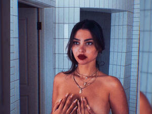 Amar posted a new photo in which she is taking off her clothes (Source: singeramar - Instagram)