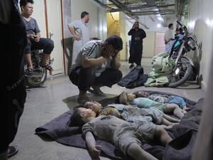 A man mourns over the bodies of his three children and their cousin at a morgue in the basement of a makeshift hospital following a reported airstrike by Syrian regime forces in Maaret al-Numan in Syria's northwestern Idlib province on August 28, 2019. (Zein Al RIFAI / AFP)