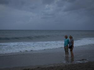 Two elders looks at the ocean after a pouring rain while there are mandatory evacuation orders for parts of Palm Beach County in Lantana Beach, Florida on September 1, 2019.  (AFP/ File Photo)