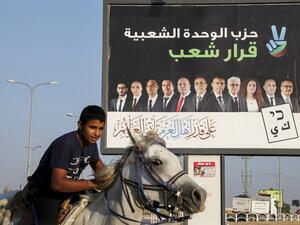 Electoral billboard for the Popular Unity party with its candidates and a slogan in Arabic reading "the decision of the people", in the Bedouin town of Rahat near the southern Israeli city of Beersheba. HAZEM BADER / AFP