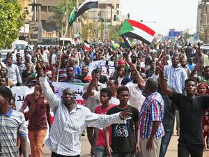 People wave the old and current flags of Sudan as they chant slogans during a mass demonstration near the presidential palace in Sudan's capital Khartoum on September 12, 2019, calling for the appointment of a new permanent chief of judiciary and prosecutor general. (AFP/ File Photo)