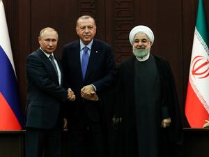 Turkish President Recep Tayyip Erdogan (C), Russian President Vladimir Putin (L) and Iranian President Hassan Rouhani (R) pose for photographs during a press conference following a trilateral meeting on Syria, in Ankara on September 16, 2019. (Adem ALTAN / AFP)