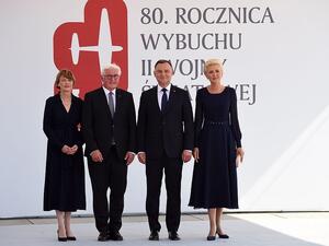 Polish President Andrzej Duda (centre right) with his wife Agata Kornhauser-Duda standing alongside German President Frank-Walter Steinmeier (centre left) and his wife Elke Buedenbender before commemorative ceremonies in Warsaw (AFP)