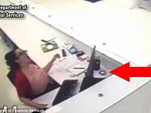 Sheyla White tried to fake a workplace injury after a sprinkler head fell onto her desk (indicated by the red arrow). She said it bounced up and hit her. (Screenshot/ Video)