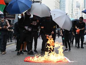 Protesters burn a Chinese national flag during a march through the streets of Hong Kong on October 1, 2019, as the city observes the National Day holiday to mark the 70th anniversary of communist China's founding. (AFP/ File Photo)