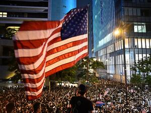 A man waves a US national flag as protesters attend a rally in Hong Kong on October 14, 2019, calling on US politicians to pass a bill that could alter Washington's relationship with the trading hub. (AFP/ File Photo)