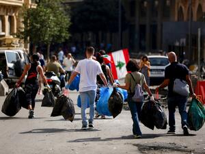 Lebanese activists clean a main road in downtown Beirut on October 19, 2019 as hundreds continued to gather in Lebanon for a third day of protests against tax increases and alleged official corruption after the security forces made dozens of arrests. (AFP/ File Photo)