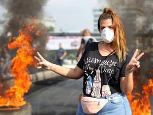 Lebanese demonstrators burn tires during a protest against dire economic conditions in the industrial zone of Dora on the northern outskirts of Beirut (AFP)