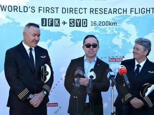Qantas Group CEO, Alan Joyce (C) Qantas pilot, Captain Sean Golding (L) and Qantas Fleet Manager, Lisa Norman (R) speak to the media after completing a non-stop test flight from New York to Sydney at Sydney international airport on October 20, 2019. The Qantas Boeing 757 completed the flight, non-stop New York to Sydney in 19 hours and 15 minutes. (PETER PARKS / AFP)