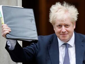 Britain's Prime Minister Boris Johnson reacts as he leaves from 10 Downing Street in central London on October 23, 2019, before heading to the House of Commons for Prime Minister's Questions (PMQS). British Prime Minister Boris Johnson said Tuesday he will pause efforts to pass his Brexit deal, after MPs gave their preliminary approval for it but rejected his timetable to push it through parliament this week. The president of the European Council, Donald Tusk, recommended that EU leaders postpone Britain's 