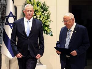 Retired Israeli general Benny Gantz (L) walks alongside President Reuven Rivlin (R) after being tasked with forming a new government, at the presidential compound in Jerusalem (AFP)