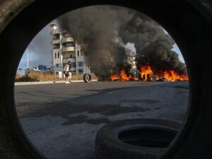 Lebanese protesters block a road with burning tires during ongoing anti-government demonstrations in the southern coastal city of Saida (Sidon) on October 28, 2019. Lebanese demonstrators set up barricades and parked cars across key roads today to protest corruption and press their demands for a radical overhaul of their country's sectarian political system. Defying pleas from Lebanon's top leaders, protesters sought to keep the country on lockdown by cutting off some of the main thoroughfares, including th