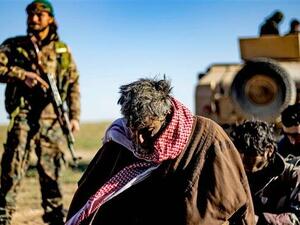 Men and boys suspected of being Daesh elements wait to be searched by members of the Kurdish-led Syrian Democratic Forces (SDF) after leaving the Daesh last holdout of Baghuz, Dayr al-Zawr Province, Syria, on March 1, 2019. (Photo by AFP)