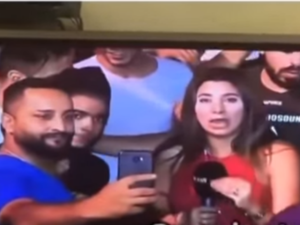 The man tried to take a selfie with the reporter after groping her. (YouTube)