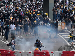 Protesters react after police fired tear gas during a rally on June 12. (AFP/ File Photo)