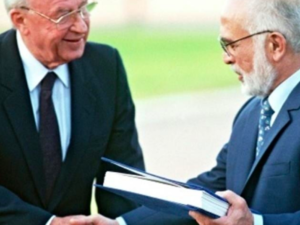 A file photo taken on November 10, 1994, shows Jordan's King Hussein (R) and Israeli Premier Yitzhak Rabin shake hands after exchanging the documents of the Peace Treaty  (AFP File)