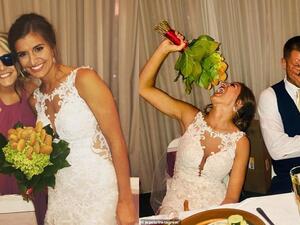 Maid of honor Jenna Spetz incorporated her cousin's love for nuggets into a surprise bespoke bouquet. Pictured: Bride Blair Hardy eating the gift next to her husband Adam Tyson. (Jenna Spetz/ Instagram)