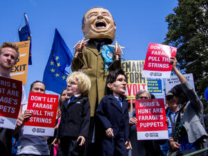 Anti Brexit protest. Stilts walker impersonating Nigel Farage holding puppets of Boris Johnson of Jeremy Hunt. (Shutterstock/ File Photo)