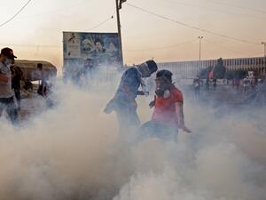 Iraqi protesters wear masks to protect themselves from tear gas as they take part in an anti-goverment demonstration in the southern city of Basra on November 8, 2019. Anti-government protests in Iraq entered their third week today amid fresh bloodshed. (AFP/ File Photo)