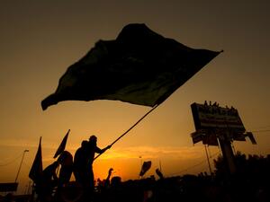 Iraqi protesters wave a flag during a demonstration during ongoing anti-government demonstrations in the southern city of Basra, on November 13, 2019. Anti-government rallies swelled in Iraq's capital and in the south as Baghdad faced new pressure from both the street and the United Nations to respond seriously to weeks of demonstrations. Hussein FALEH / AFP
