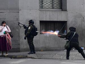Riot police fire tear gas to disperse supporters of Bolivian ex-President Evo Morales and locals discontented with the political situation during a protest in La Paz on November 13, 2019. Bolivia's exiled ex-president Evo Morales said Wednesday he was ready to return to "pacify" his country amid weeks of unrest that led to his resignation.  RONALDO SCHEMIDT / AFP