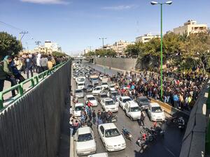 Iranian protesters block a road during a demonstration against an increase in gasoline prices in the central city of Isfahan, on November 16, 2019. One person was killed and others injured in protests across Iran. (AFP)