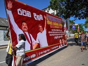 Supporters of Sri Lanka Podujana Peramuna (SLPP) party presidential candidate Gotabaya Rajapaksa carry cut-out placards to celebrate in Colombo on November 17, 2019. (AFP)