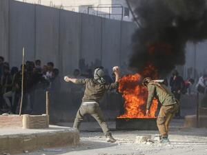 Syrian protesters hurl stones amid clashes with Turkish forces following a demonstration against Turkey's presence in northern Syria on November 17, 2019 in the town of al-Bab in Syria's northern Aleppo governorate. Turkey and its Syrian proxies control several pockets of territory on the Syrian side of the border as a result of successive incursions in 2016-17, 2018 and 2019. Bakr ALKASEM / AFP