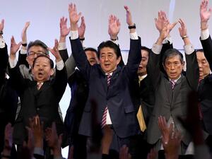 Japan's Prime Minister and ruling Liberal Democratic Party (LDP) leader Shinzo Abe (C) leads 'Banzai' shouts at the end of his party convention in Tokyo. (AFP/ File Photo)
