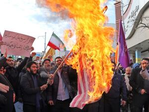 Iranian men burn a US flag during a protest in support of the Islamic republic's government and supreme leader, Ayatollah Ali Khamenei, in the northwestern city of Ardabil on November 20, 2019, as President Hassan Rouhani said the country's people had defeated an "enemy conspiracy" behind a wave of violent street protests. (AFP/ File Photo)