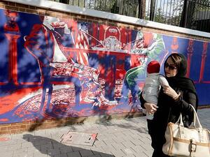 Another mural shows Iranian and American politicians sitting at a table in the White House  (AFP)