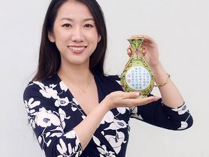 Sworders Fine Art Auctioneers' expert Yexue Li holds the little vase which was sold for £484,000 yesterday. (Sworders )