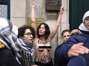 A topless woman, who had 'we're not promoting secularism' written on her chest, also joined the protest but appears to be from the feminist group Femen protesting for a secular society  (dailymail)