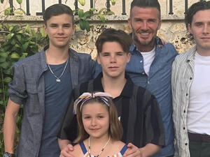 David was seen hugging Harper as she cooed over the colourful display