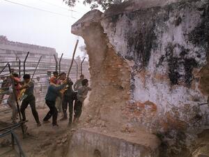 On Dec. 6, 1992, Hindu attackers hit the wall of the 16th century Babri Masjid with iron rods, part of a mob that tore down the mosque. Thousands were killed in rioting that followed the mosque's destruction. (Douglas E. Curran/AFP/Getty Images)