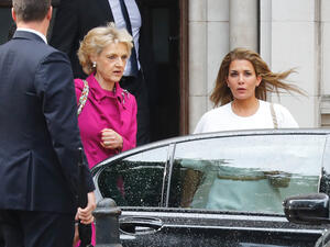 Princess Haya bint al-Hussein of Jordan (right), accompanied by her lawyer lawyer Fiona Shackleton (center), leaves the High Court in London on Tuesday. (Tolga Akmen/AFP/Getty Images)