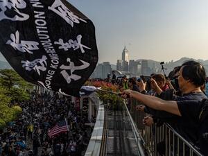 People take part in a march from Tsim Sha Tsui to Hung Hom in Hong Kong on December 1, 2019. Police fired tear gas and pepper spray in Hong Kong on December 1 as tens of thousands of black-clad protesters flooded into the streets, a week after pro-democracy candidates scored a landslide local election victory. (Philip FONG / AFP)